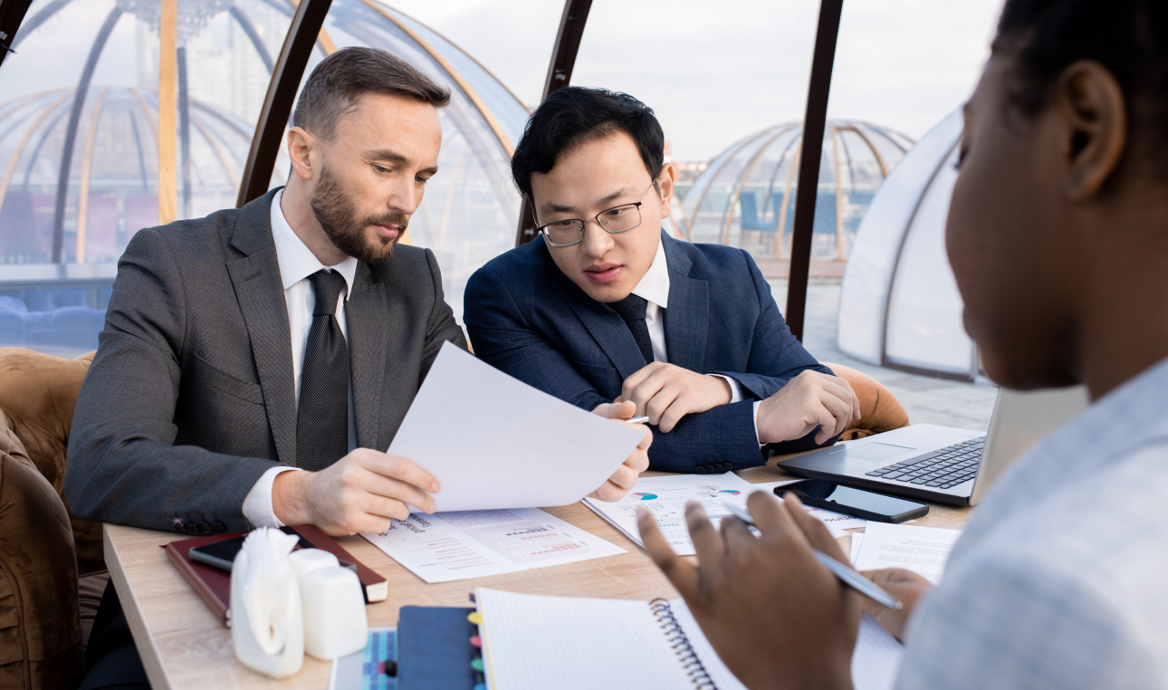 two foreign business partners discussing terms contract